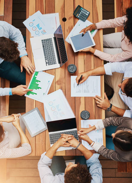 istock Data, analytics and hands of business people at workshop for planning, strategy and stats for tech sales growth. Laptop, paperwork and team in meeting with charts, graphs and collaboration from above 2160922356