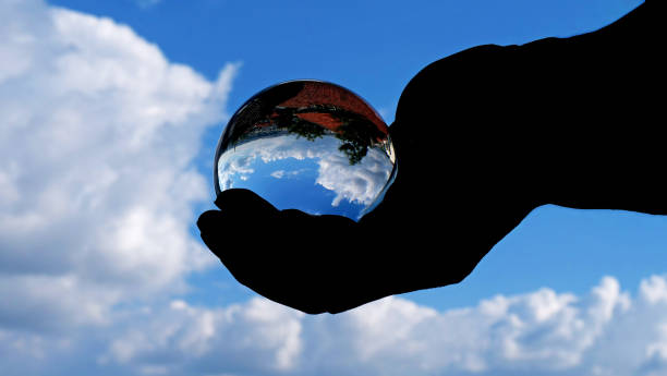 nature landscape with glass globe in hand