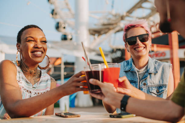 Group of friends at table toasting with drink