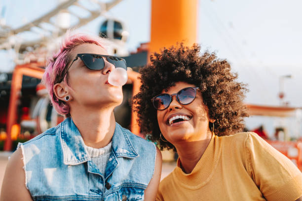 Two friends having fun bubble gum
