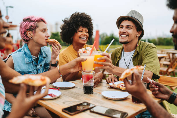 istock Group of friends at table toasting with drink 2160927040