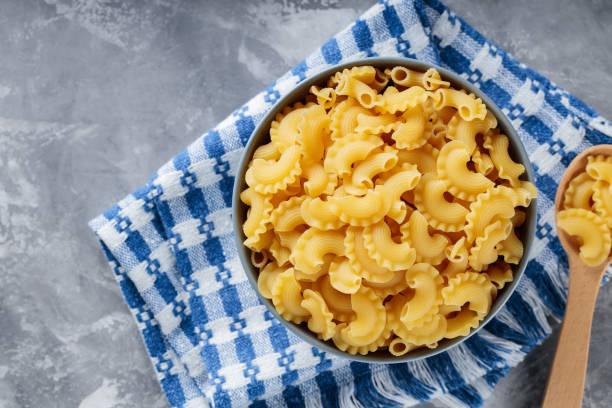 istock Uncooked Creste di Gallo Pasta in Bowl on Gray Concrete Background, Copy Space 2160928014