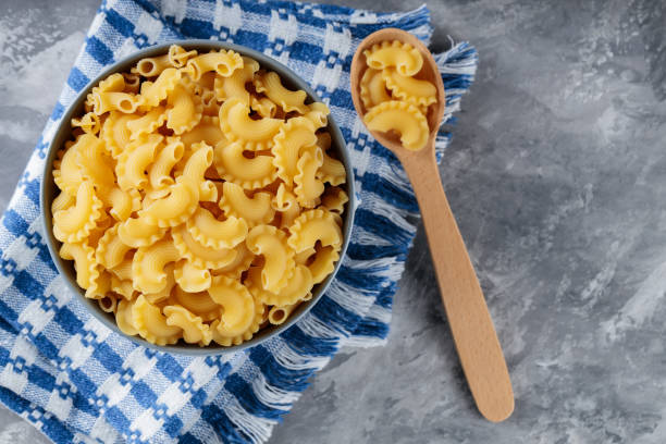 istock Uncooked Creste di Gallo Pasta in Bowl on Gray Concrete Background, Copy Space 2160928020