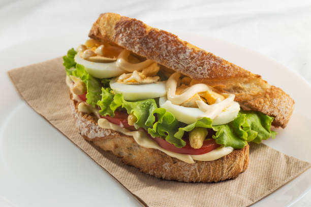 Vegetable sandwich with tomato, lettuce, asparagus, egg and mayonnaise. Healthy fast food concept.