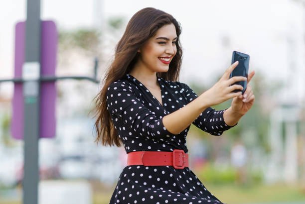 Young beautiful woman using smart phone