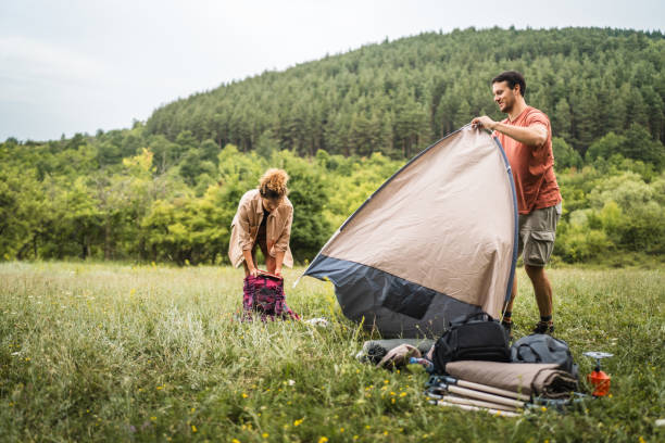 istock Couple pack a tent after finish camp trip 2160929774