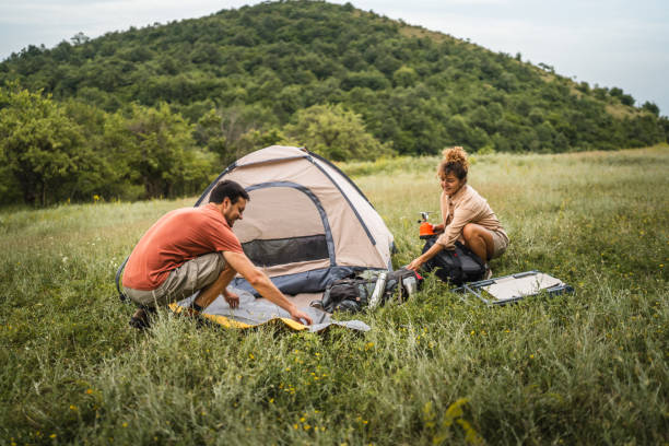 istock Couple pack equipment and theirs backpack after finish camp trip 2160929824