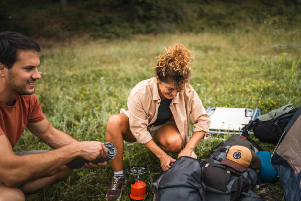 istock Couple pack equipment and theirs backpack after finish camp trip 2160929825