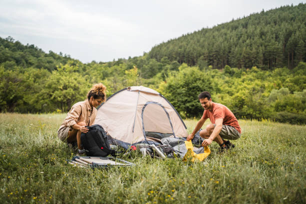 istock Couple pack equipment and theirs backpack after finish camp trip 2160929826