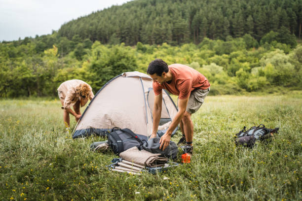 istock Couple pack a tent after finish camp trip 2160929882