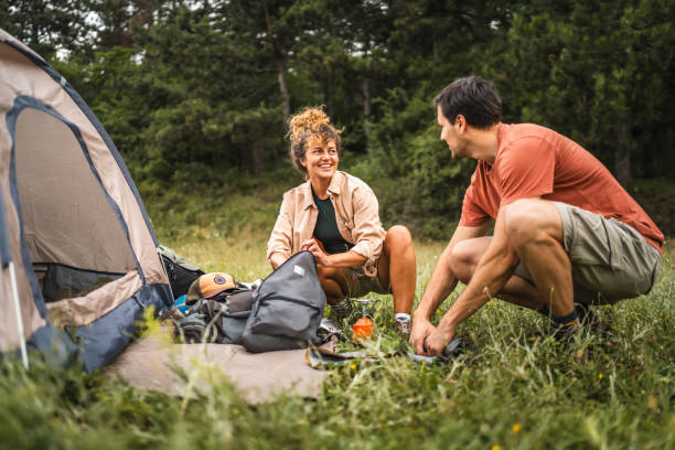 istock Couple pack equipment and theirs backpack after finish camp trip 2160929952