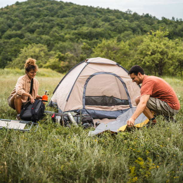 istock Couple pack equipment and theirs backpack after finish camp trip 2160930110