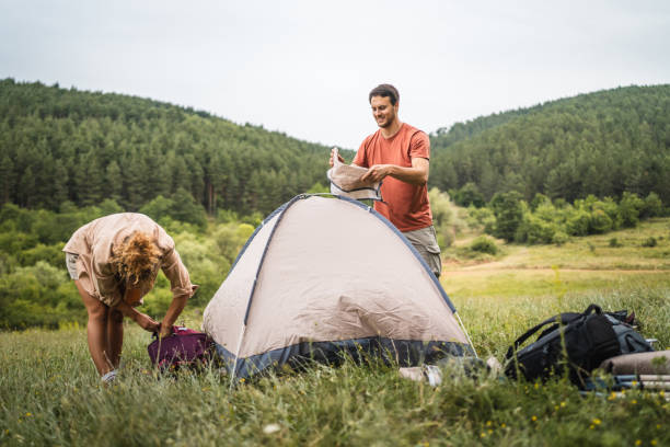 istock Couple pack a tent after finish camp trip 2160930379