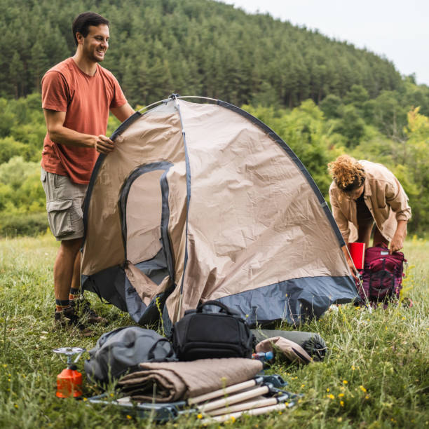 istock Couple pack a tent after finish camp trip 2160930478