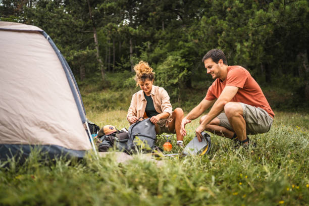 istock Couple pack equipment and theirs backpack after finish camp trip 2160930634