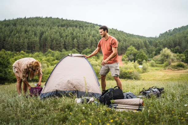 istock Couple pack a tent after finish camp trip 2160930778