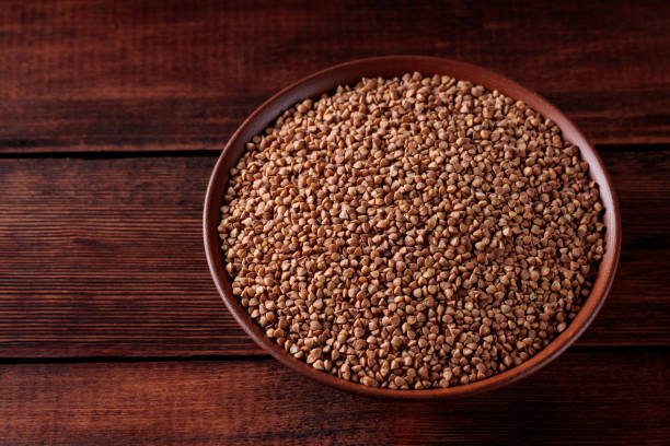 istock Uncooked Buckwheat Grains on Wooden Boards, Copy Space 2160932023
