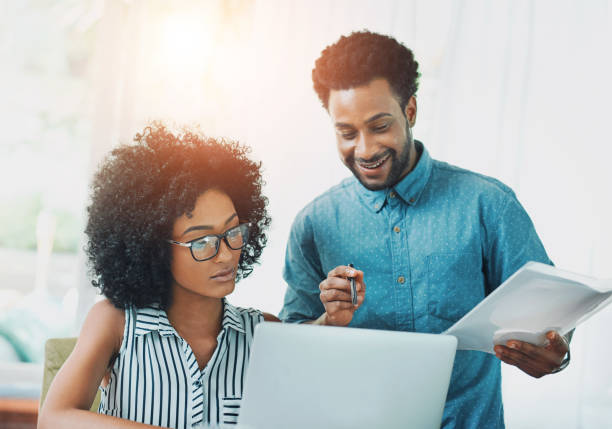 istock Office, documents and people with laptop in discussion for brainstorming, collaboration and project plan. Software development, man and woman in conversation with tech for idea, review or ux solution 2160932084