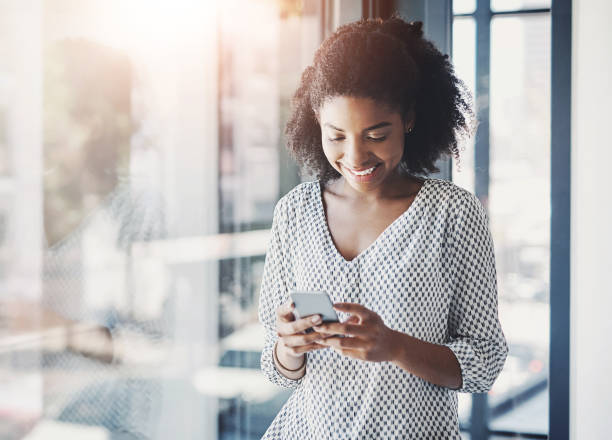 istock Business, black woman and typing on smartphone in office for text message, networking or communication. Professional, employee and happy with phone at workplace for mobile chat or social media scroll 2160936249