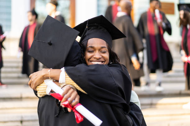 istock Two female graduates embracing each other 2160938418