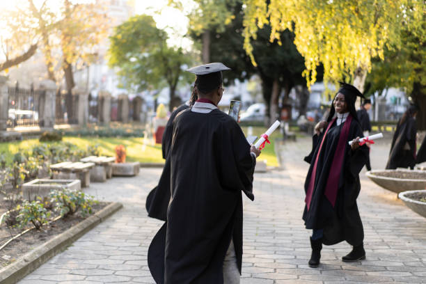 istock Happy graduates with their diplomas on their way home 2160938428
