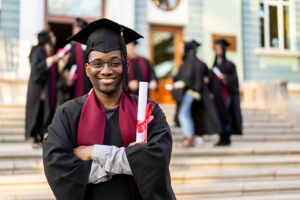 istock Male student looking very happy on graduation 2160938429