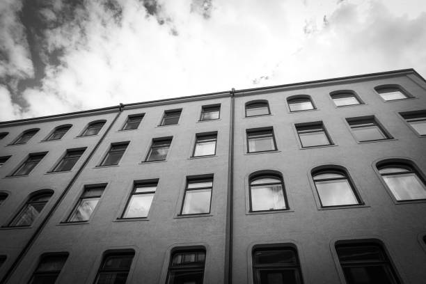 Low angle view of a building against sky in black and white