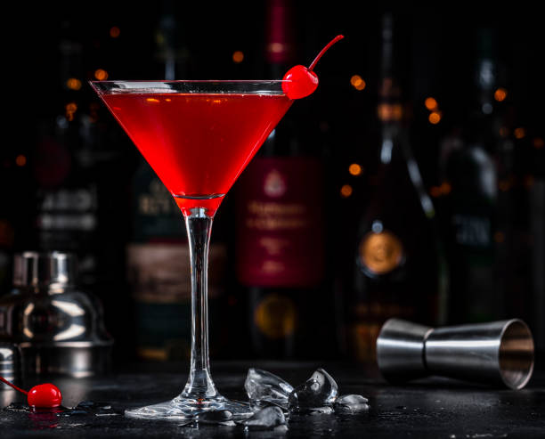 istock Red alcoholic cocktail drink with cherry on dark background, bar counter with bottles 2160940562