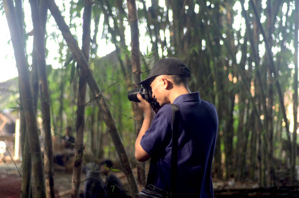 istock Photographer taking shot in bamboo forest. 2160941835