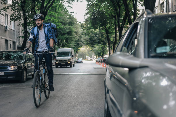 istock Urban Cyclist Navigates Morning Traffic 2160944649