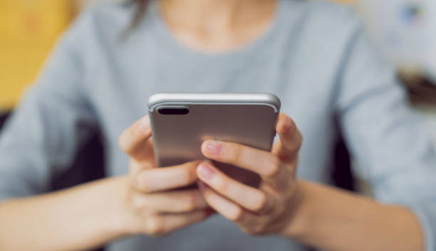 istock Hand  holding a smartphone and using social media on internet. 2160946009