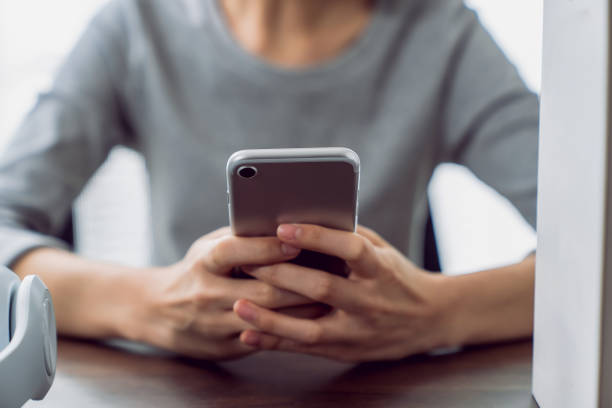 istock Woman holding a smartphone and using social media on internet. 2160946082