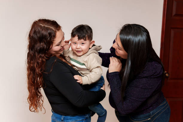 istock Two women are holding a baby 2160951358