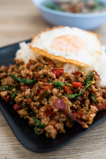 istock Stir fried Thai basil with minced pork and a fried egg. 2160952357