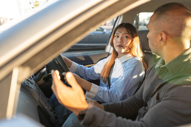 istock Young Female Taking Lessons At Driving School 2160953895
