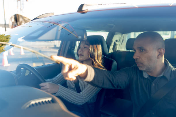 istock Male Driving Instuctor Pointing Out Hazards 2160953925