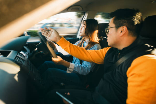 istock Driving instruction, woman is on a test drive, learning to drive. 2160955091