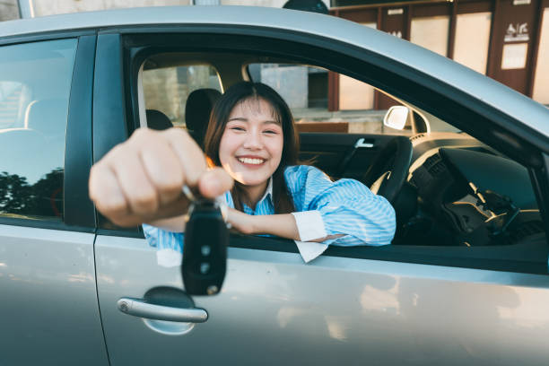 istock Holding her new car key. 2160955117