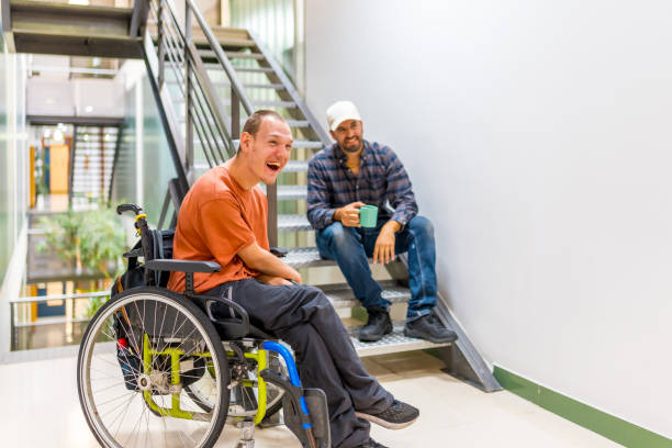 Work mates with disability having fun in a work break Happy work mates with disability having fun in a work break office buddies stock pictures, royalty-free photos & images