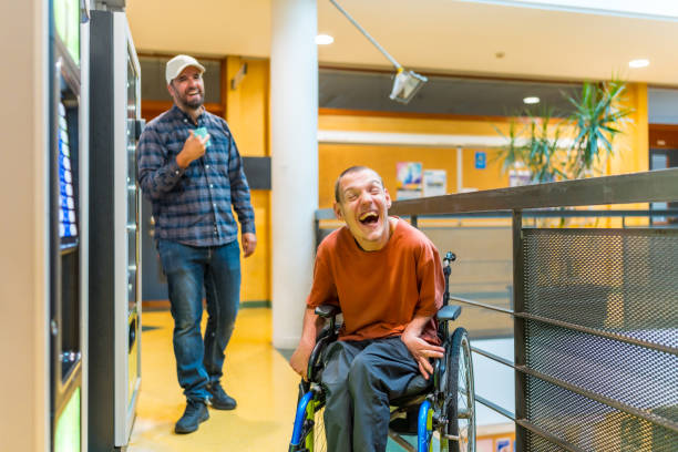 istock Man with cerebral palsy laughing next to coworker 2160956232