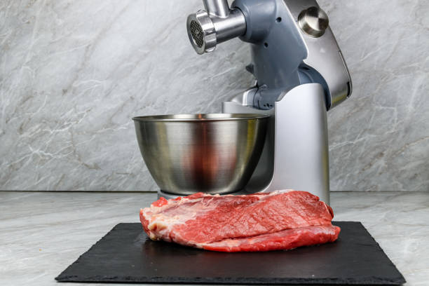 istock Modern food processor with meat grinder and peace of pork meat on a kitchen table 2160956495