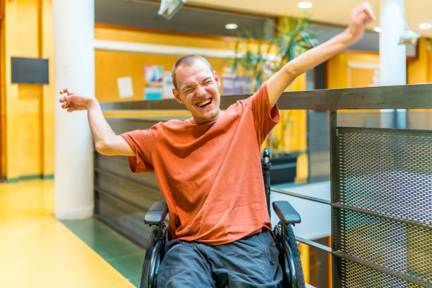 istock Successful man with disability celebrating in a modern coworking 2160956638