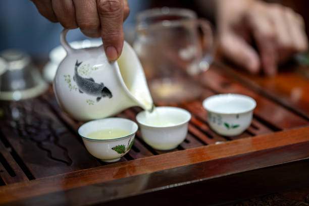 istock Some tea ceremony tea sets are on table. The tea table is on the table. Tea sets such as teapots and cups are in wooden trays. process of pouring tea during a tea ceremony in China. 2160957070
