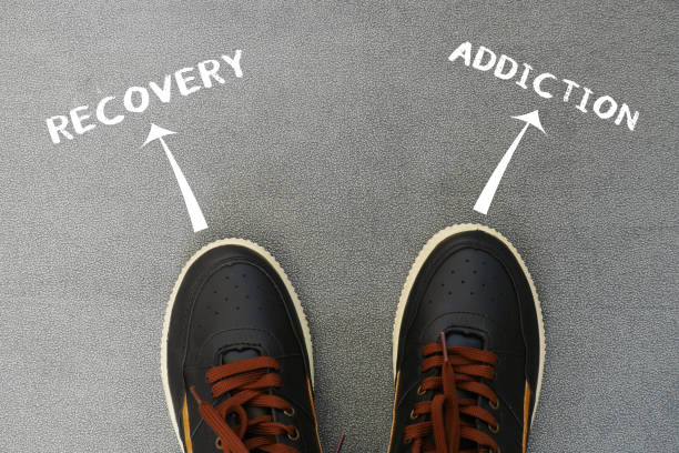 istock Feet towards two choices between Recovery or addiction 2160958200