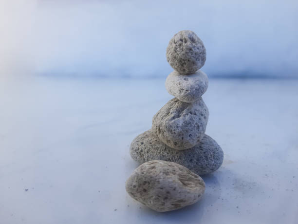 Balance stones on top of each other on the pebbly seaside