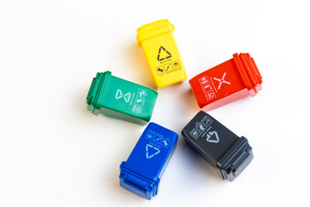 Close up of miniature trash bins on white background.