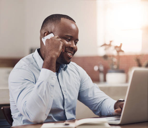 istock Black man, phone call and communication in home with laptop, chat for cryptocurrency trading. Male trader, discussion and mobile for advice with stock market or finance deal, happy and investment 2160960263