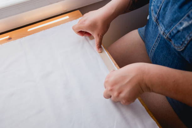 istock Hispanic Woman Cheerfully Making Pillow Case with Fabric Tape 2160961619