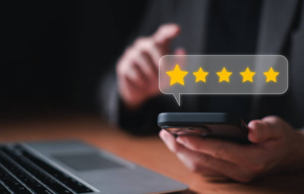 istock Selective focus at finger of business man while point finger to choose feedback on five star excellent customer service with five star score with smile. Service evaluation concept with futuristic icon 2160961796