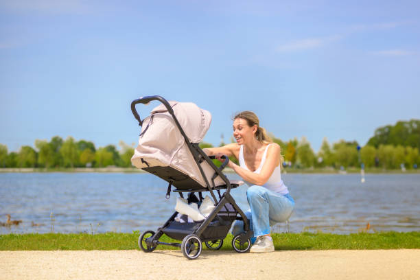 istock Mother with Baby Stroller in Scenic Park 2160966050